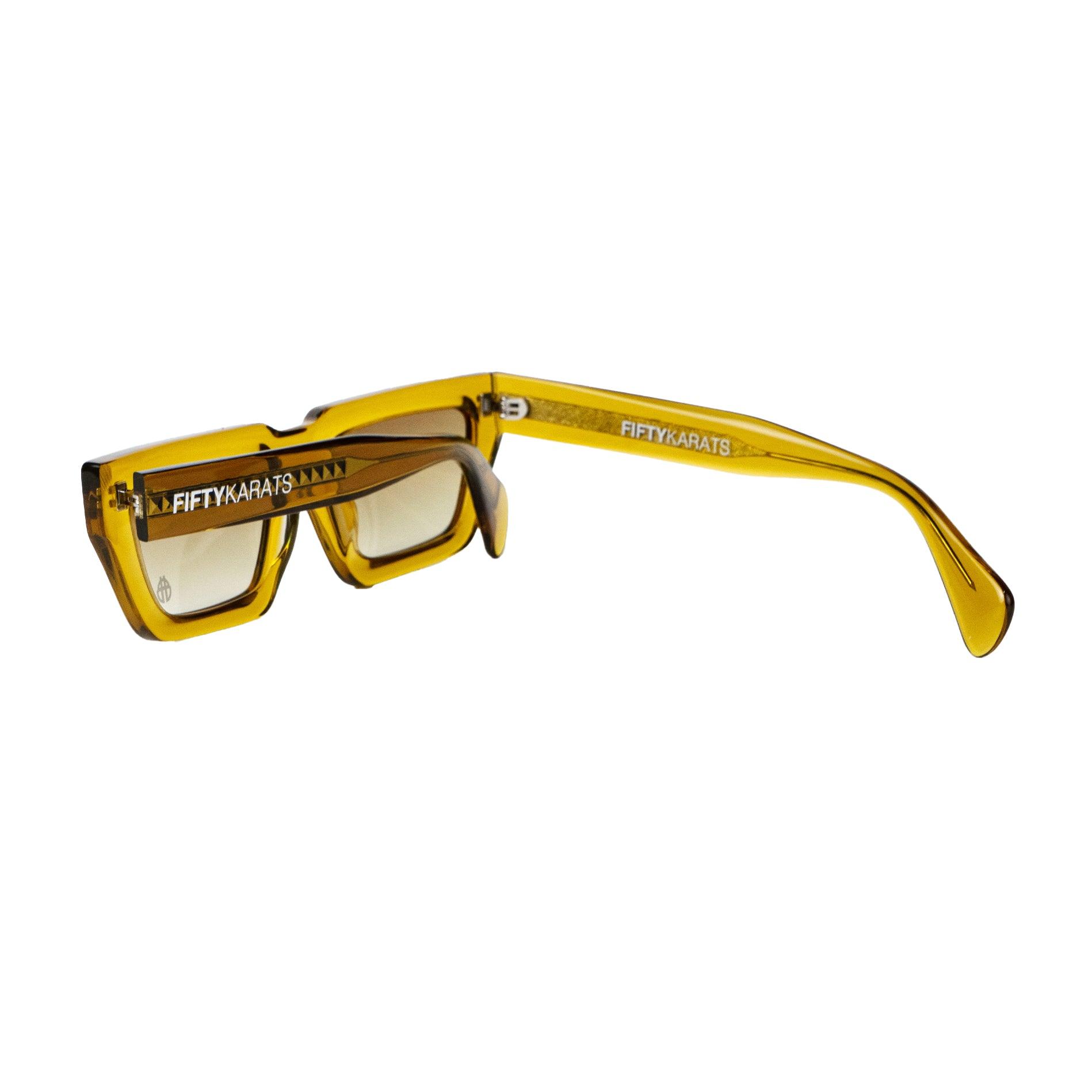 Topaz Conductor Sunglasses Folded with beetle icon logo on lens and Fifty Karats logo on arm
